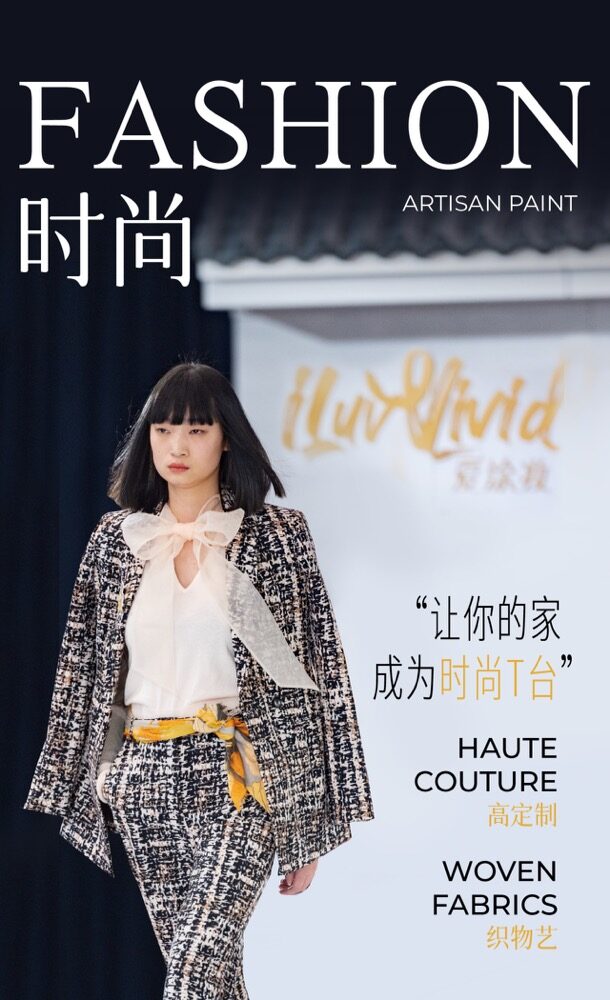 Model walks runway in a textured tweed suit with a bow-neck blouse and yellow sash.