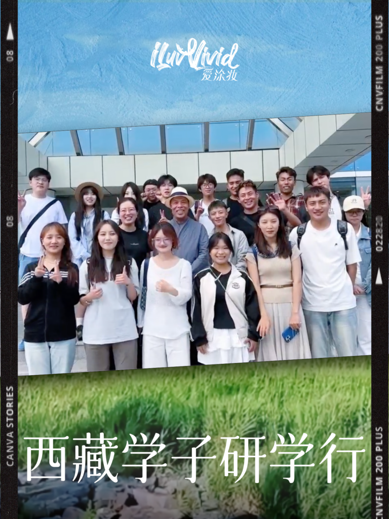A diverse group of students and adults pose for a photo outdoors in front of a building.