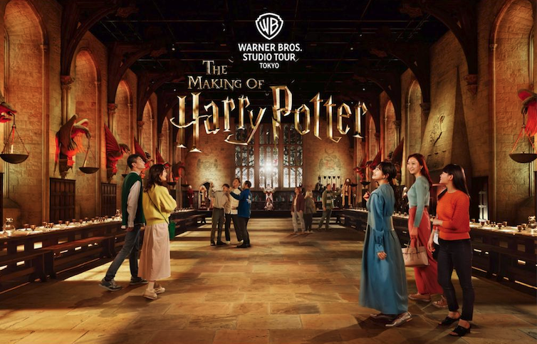 Visitors explore the Great Hall set at the Warner Bros. Studio Tour Tokyo, The Making of Harry Potter.