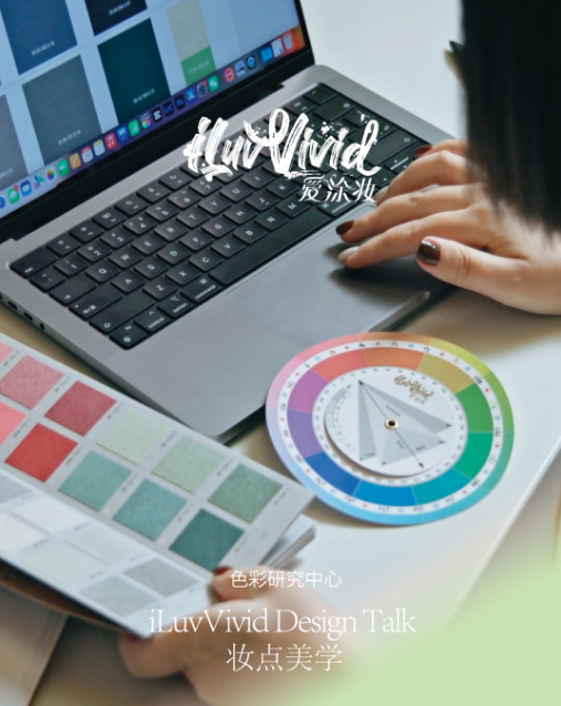 A person's hands select color swatches near a laptop and a color wheel.