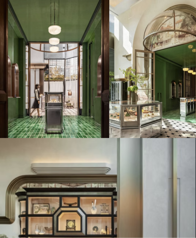 A woman walks past a display case in a hotel lobby with green tiled floors and walls.