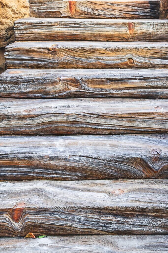 Weathered wooden steps show intricate grain patterns and a rustic, natural texture.
