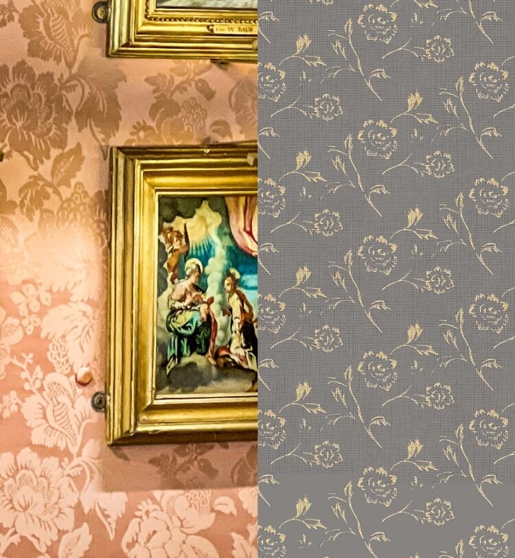 A framed religious painting hangs on a wall with ornate floral wallpaper.