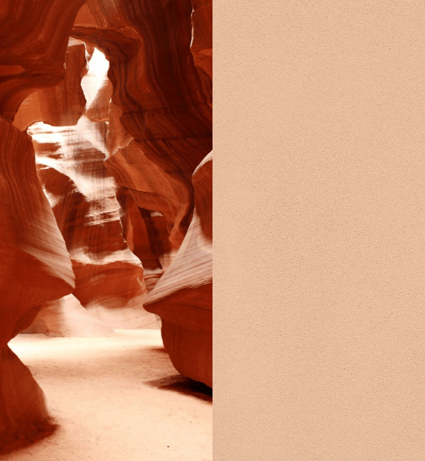 Sunlight streams into a narrow sandstone canyon with smooth, flowing walls.