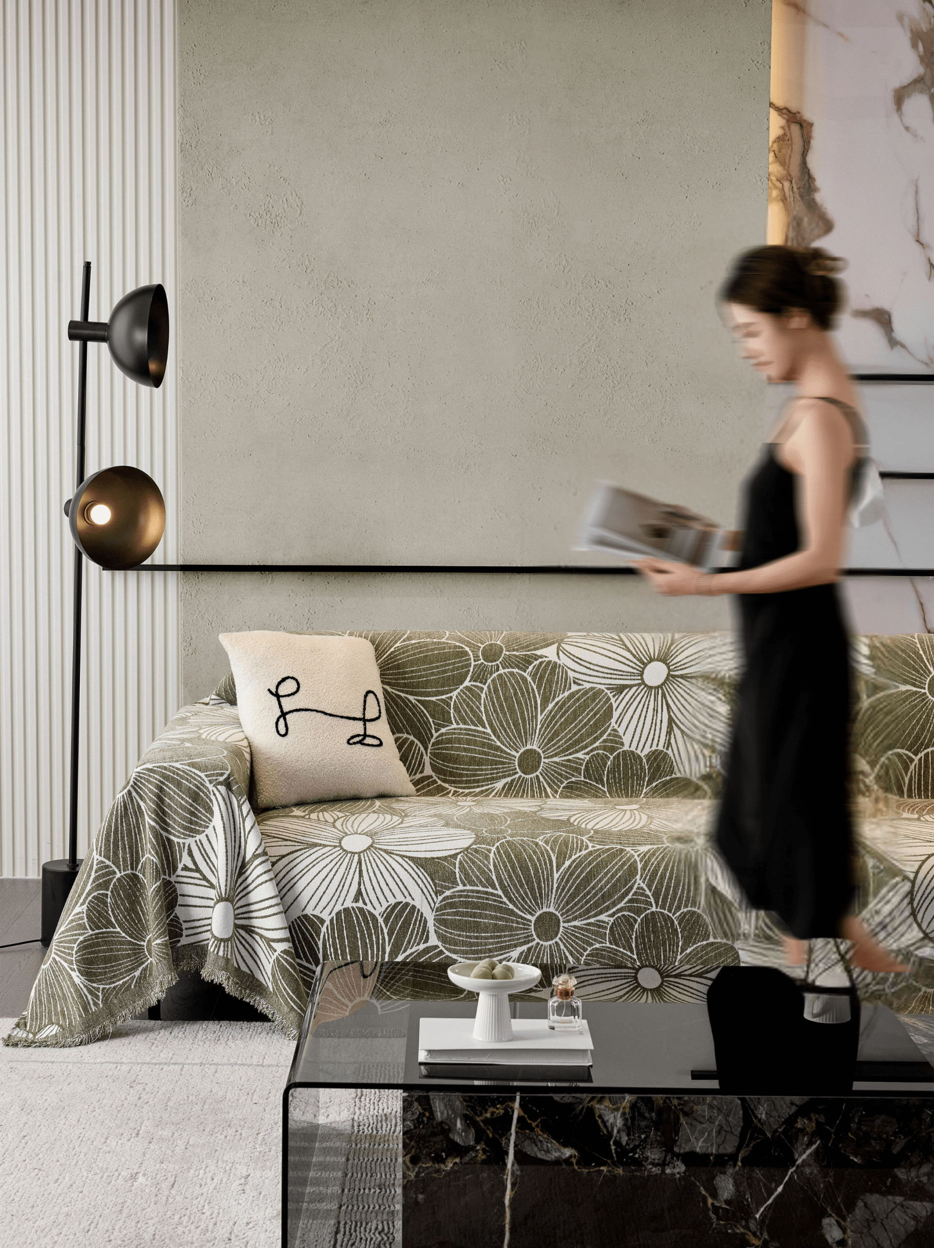 A woman walks past a floral-covered sofa in a modern living room with a floor lamp.